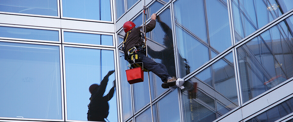 Window cleaner cleaning office windows